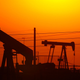 A photo of two oil wells taken at sunset in California.